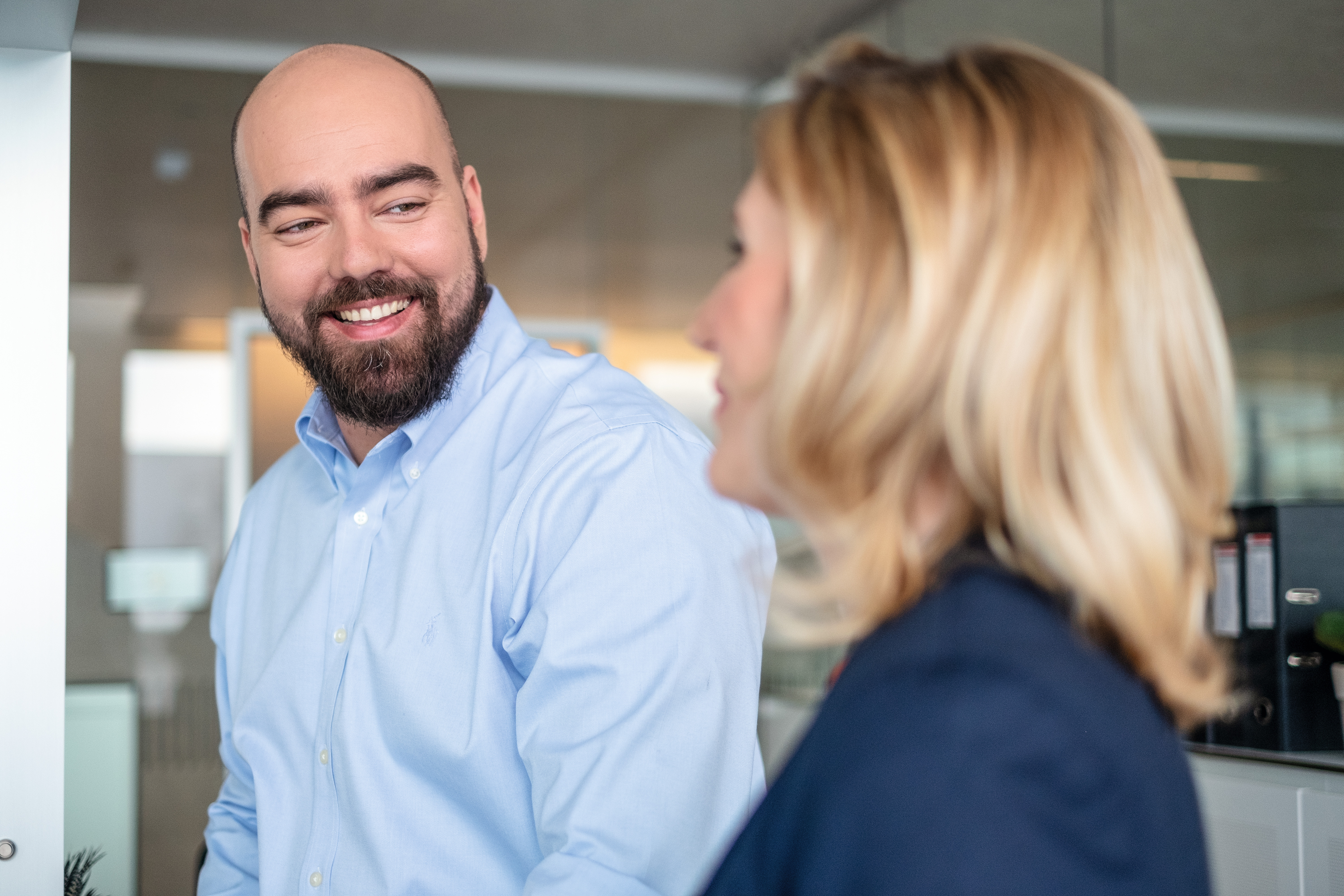 Two employees conversing at the office