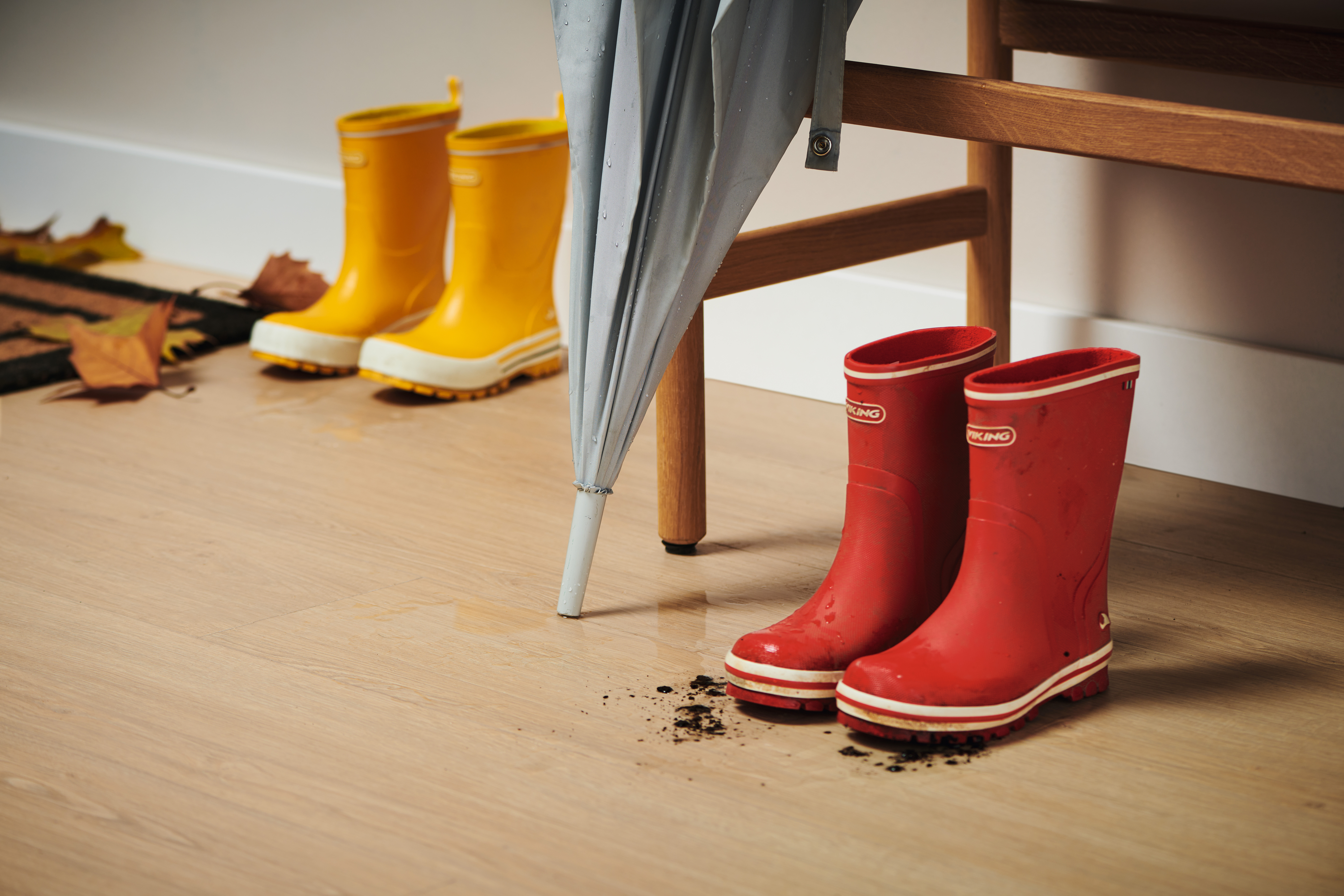 Rubber boots with mud in the hallway on EGGER Laminate Flooring with Aqua CLIC it! - EL1009