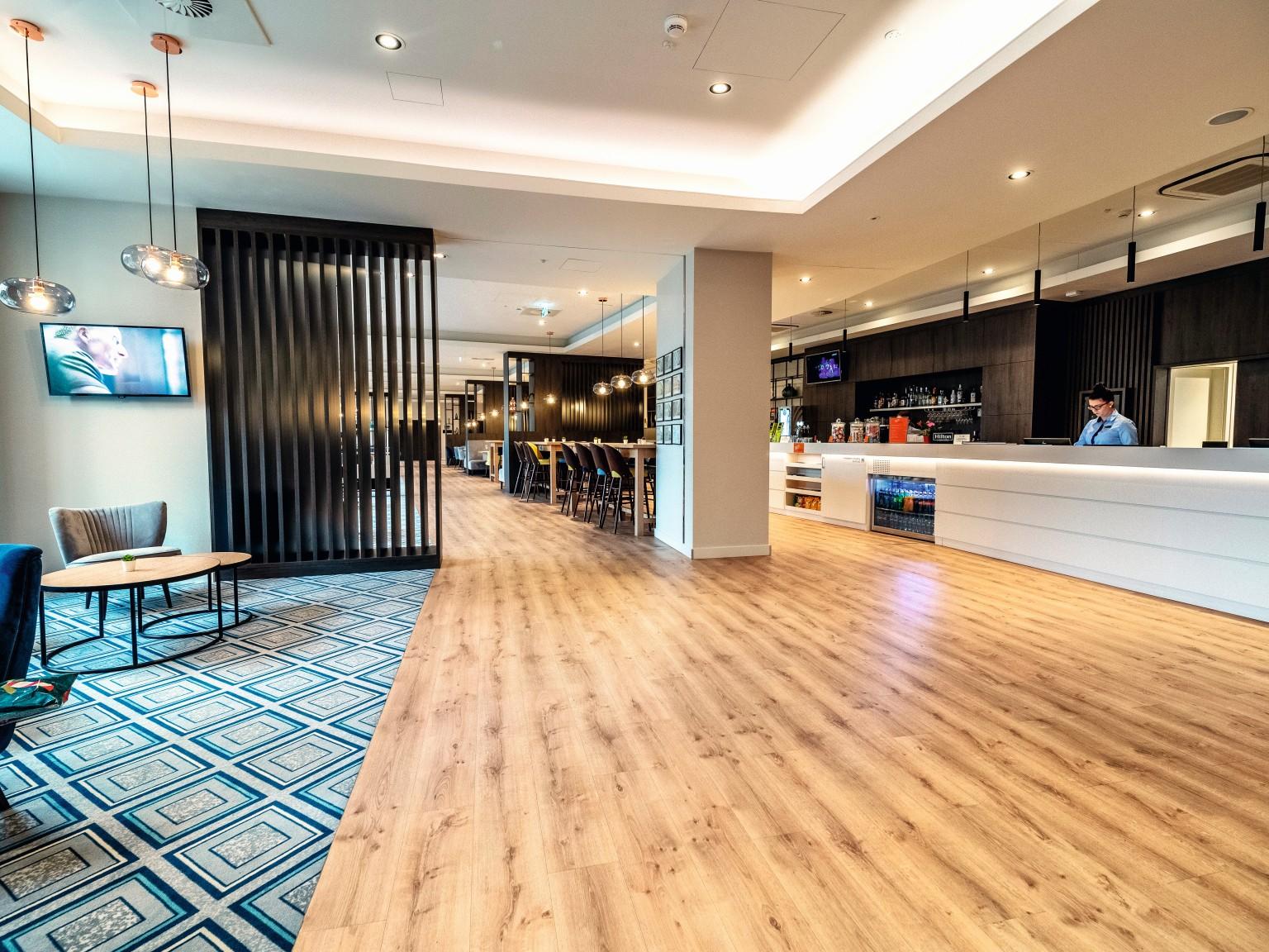 The reception area looks very elegant with dark Graphite Denver Oak used in combination with white elements.