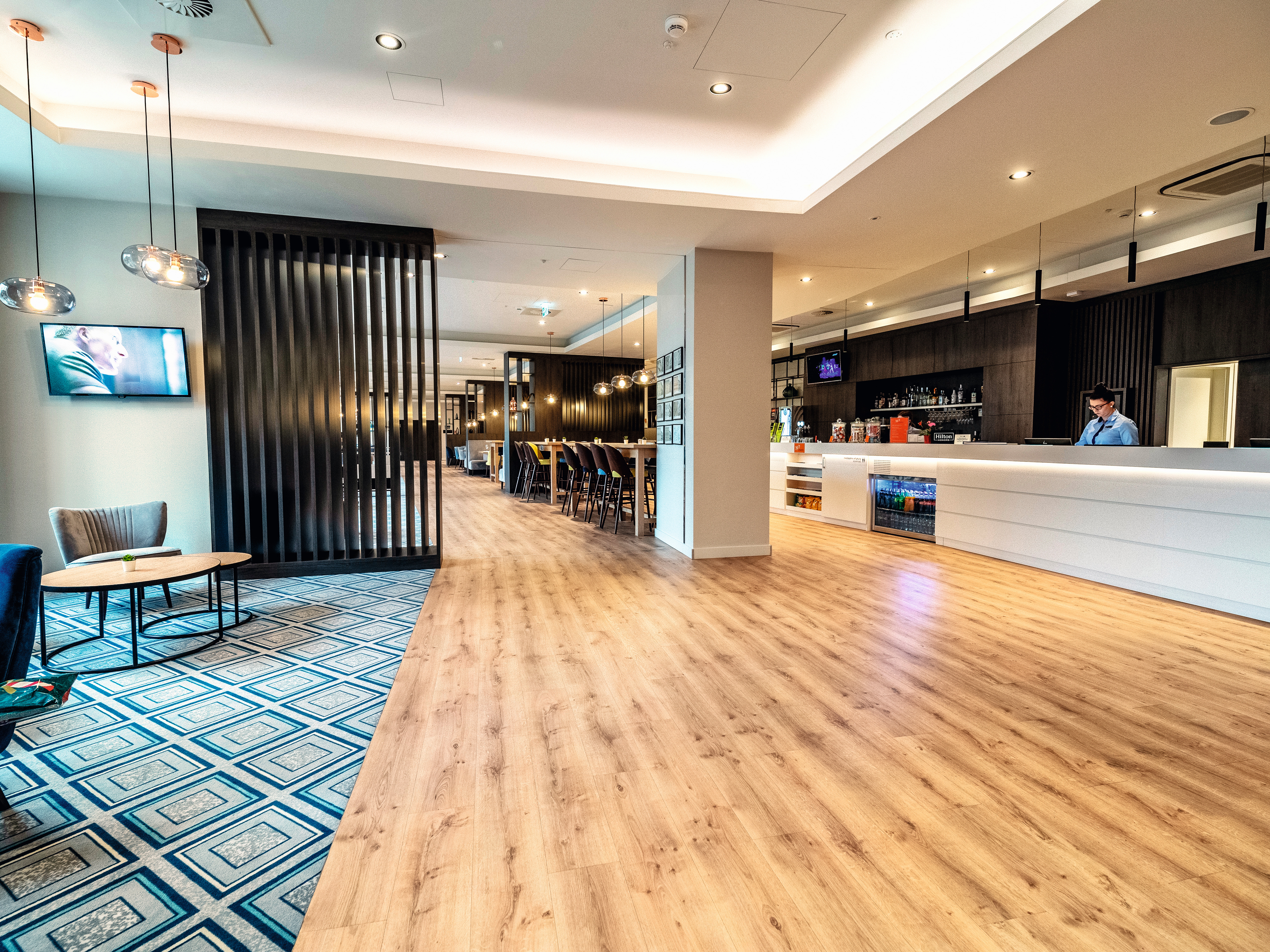 The reception area looks very elegant with dark Graphite Denver Oak used in combination with white elements.