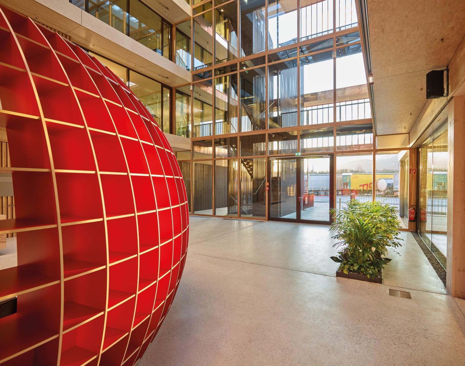 The red half-shell made of MDF features accents and functions as waiting area. © Christian Vorhofer