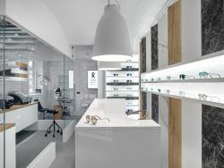 Different materials punctuate the white shelves and furniture.
