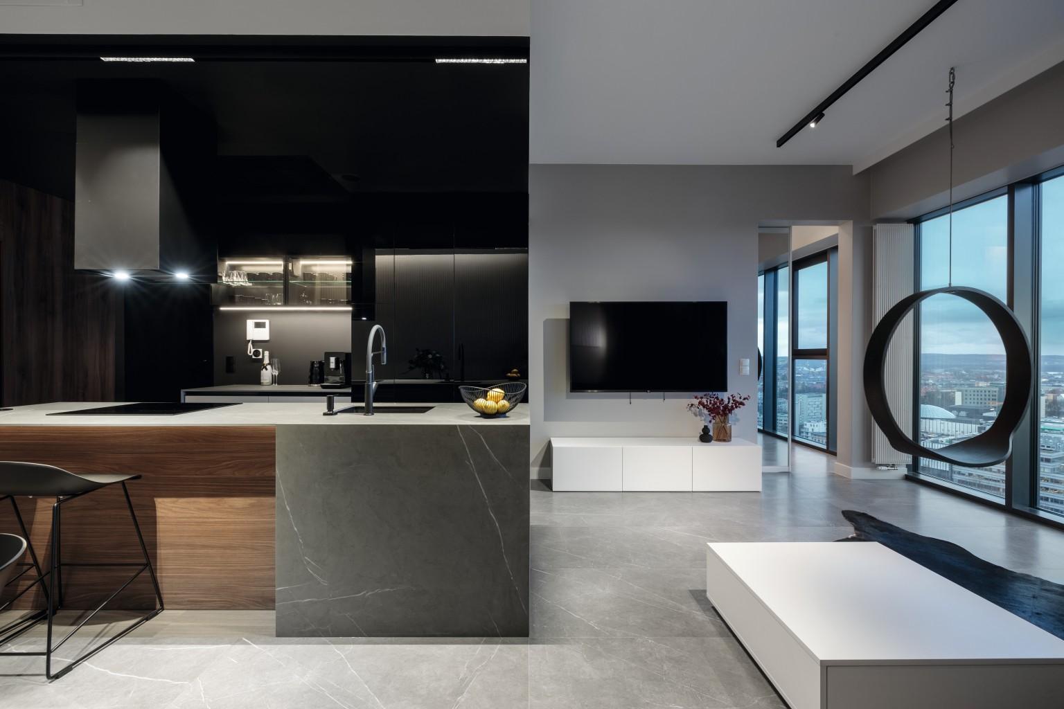 The kitchen in U999 PG Black and the kitchen island are real eye-catchers in this appealing interior design. 