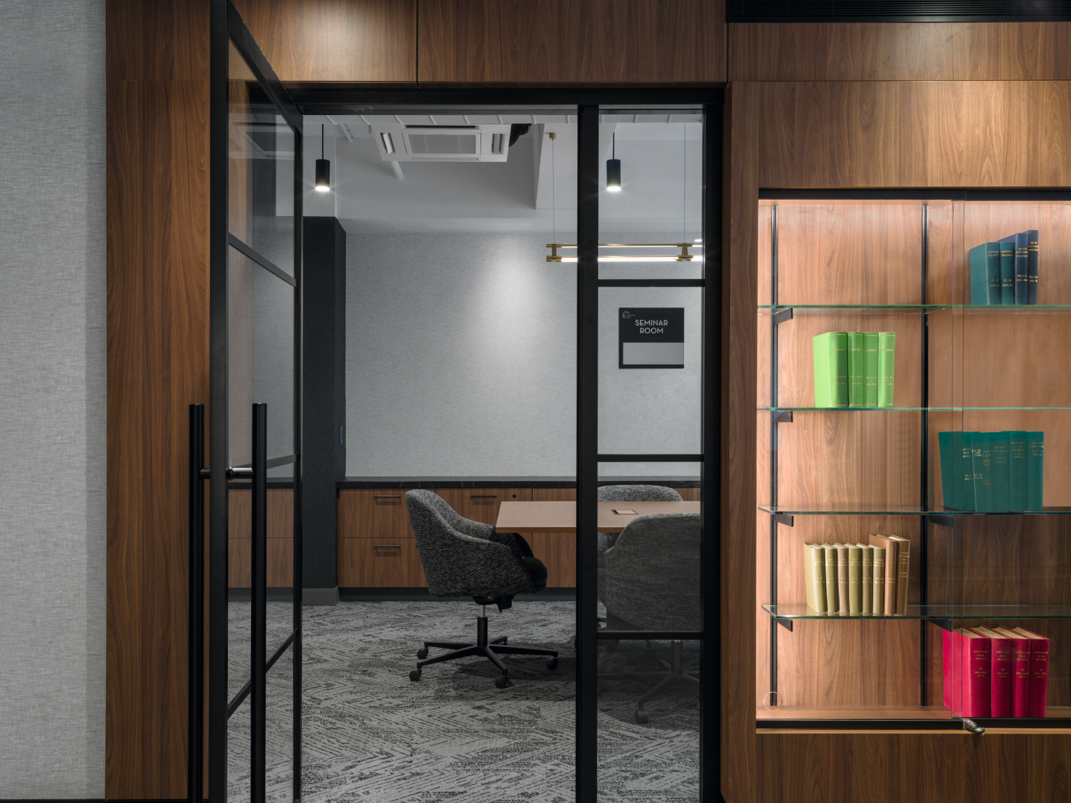 Illuminated shelving and rich H3791 ST12 Auburn Carini Walnut millwork. 