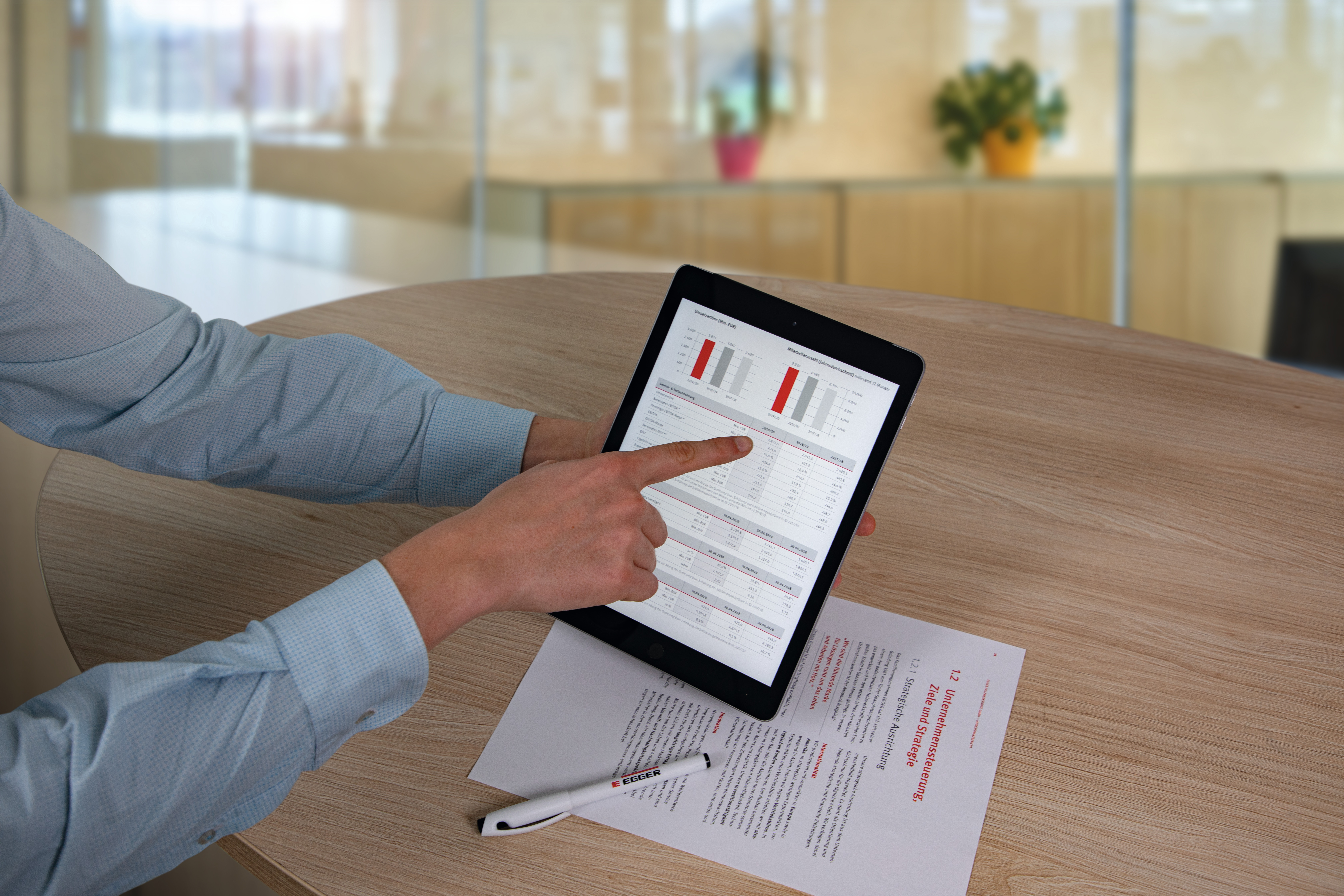 Finger pointing to tablet with financial figures