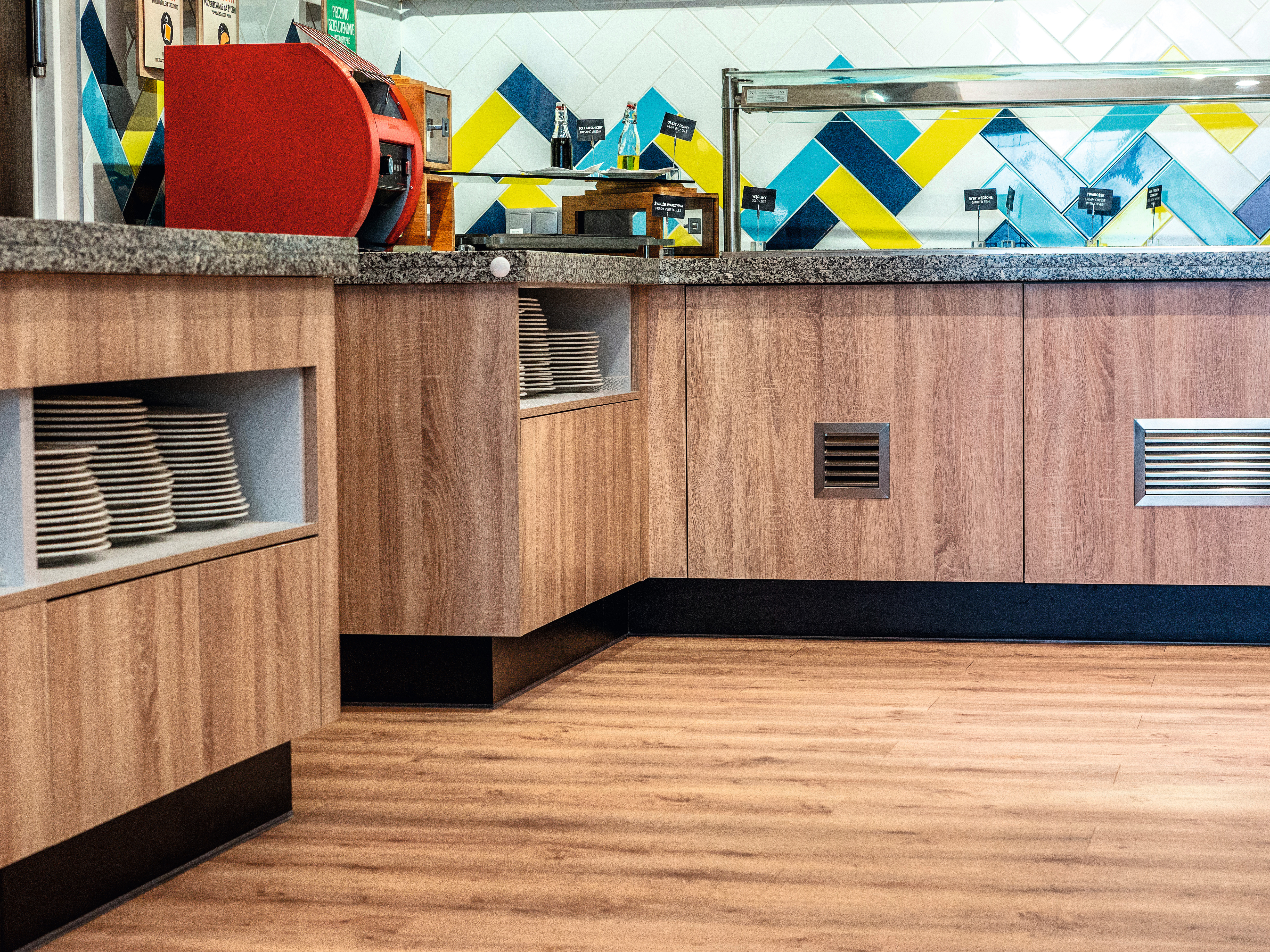 The cabinets in the buffet area feature H1145 ST10 Natural Bardolino Oak.